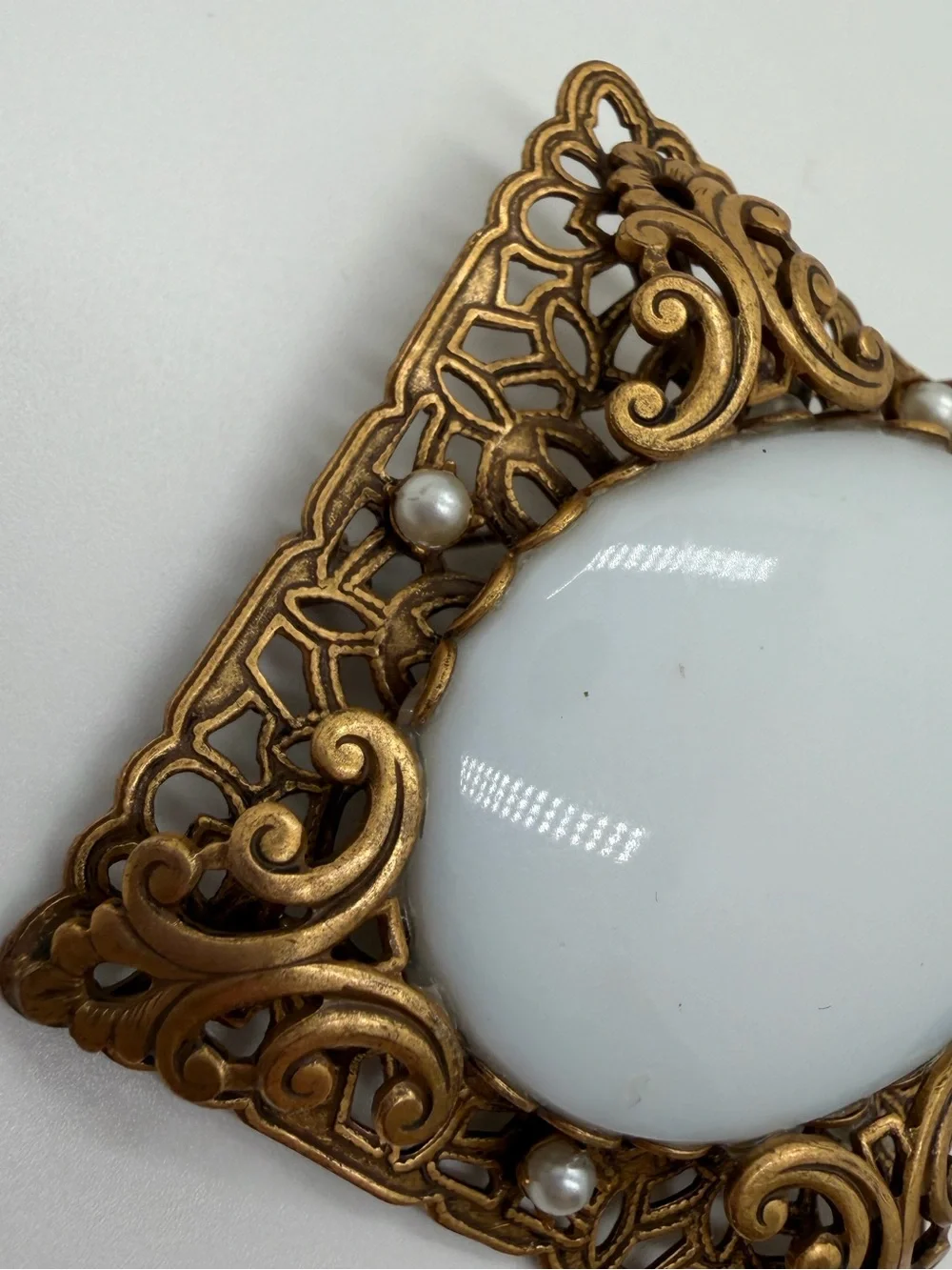Victorian style filigree gold tone milk glass brooch